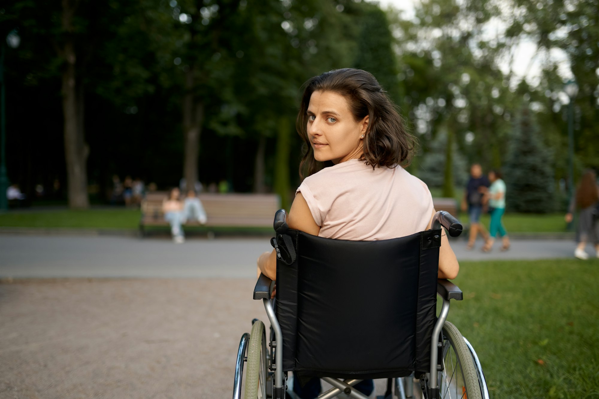 Handicapped woman in wheelchair, back view