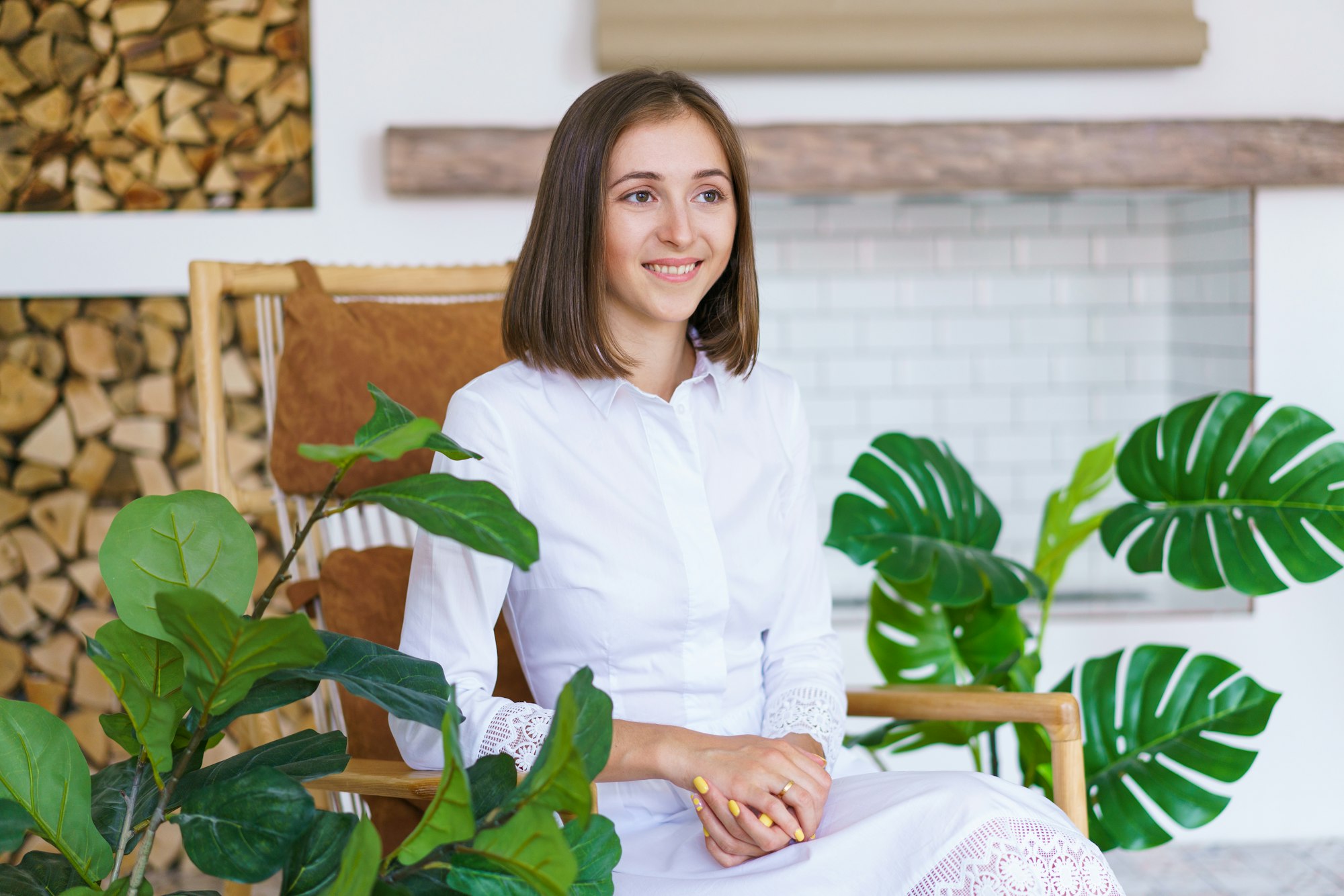 Portrait Of Cute Young Woman Psychologist In Cozy Light Office Sits.jpg