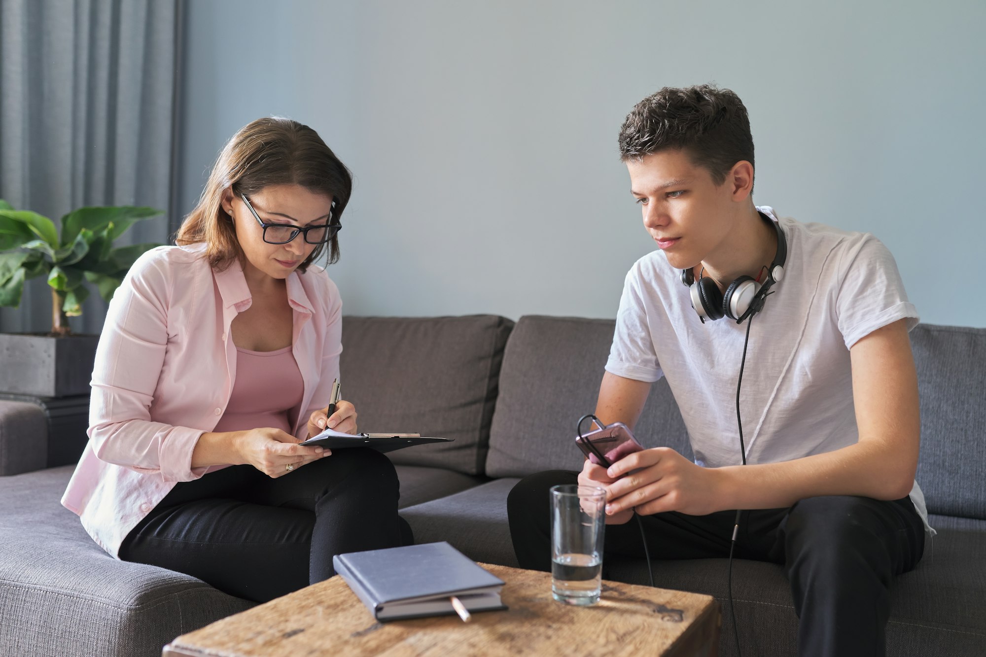 Teen Boy Talking To Psychologist Individual Therapy Session For Teenage With Doctor.jpg