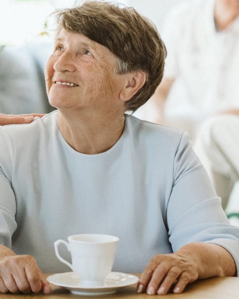 Happy senior woman and helpful caregiver, nursing home concept photos