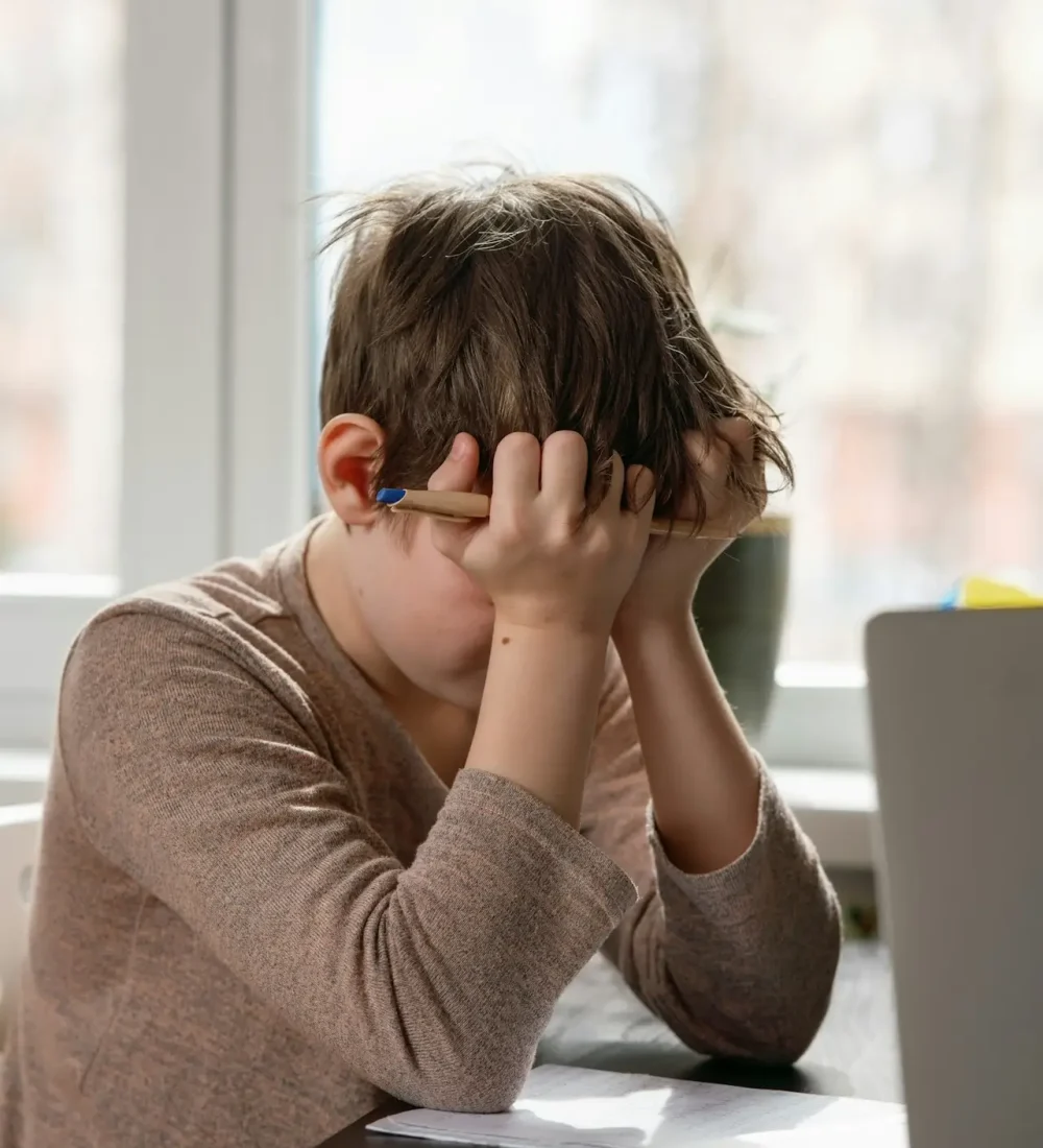 Problems with remote online education. A schoolboy boy studies at home and does school homework